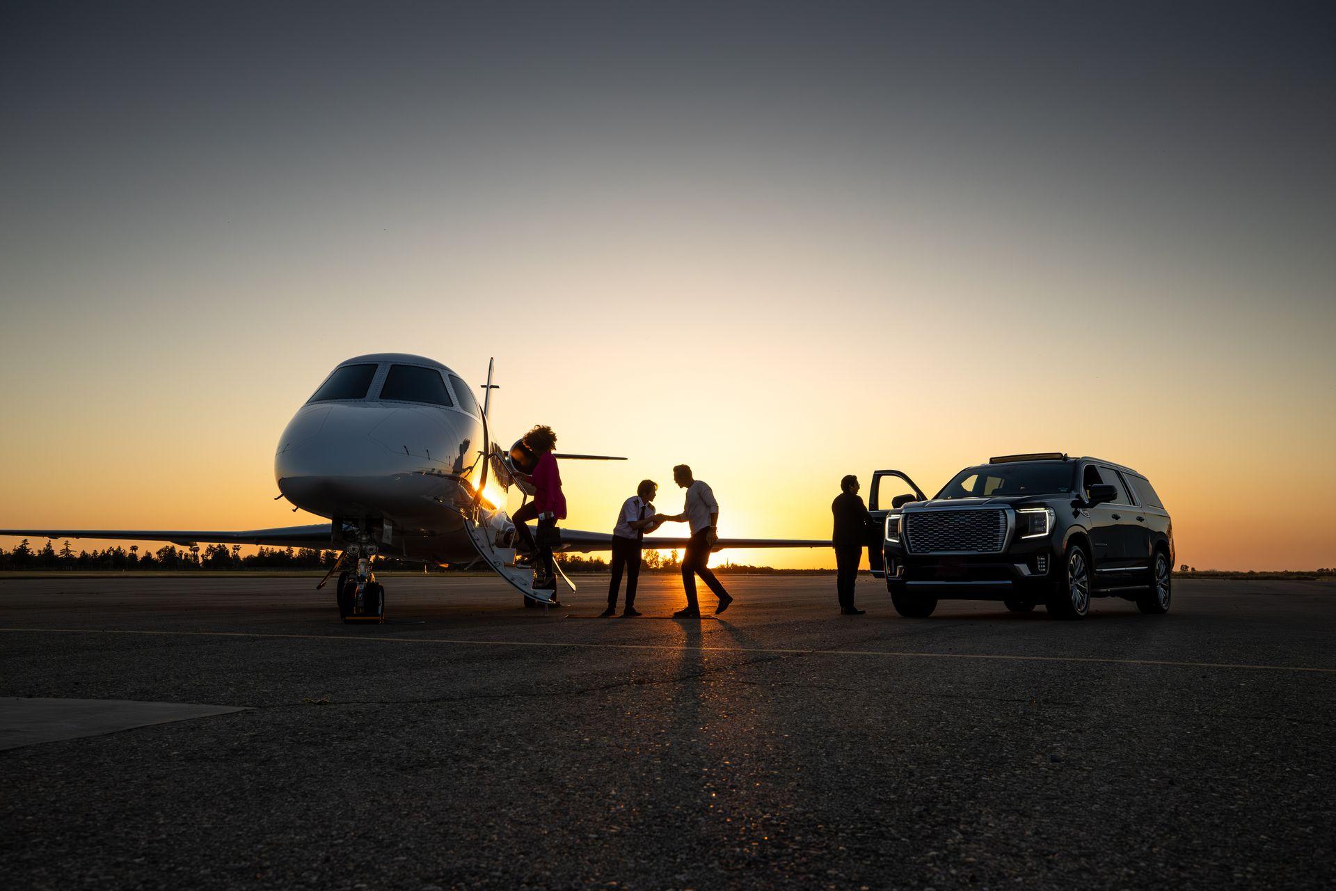 Premium chauffeur service — private jet and black SUV at sunset
